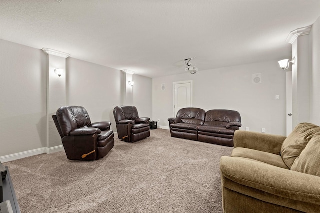 living room featuring baseboards, ornate columns, and carpet flooring