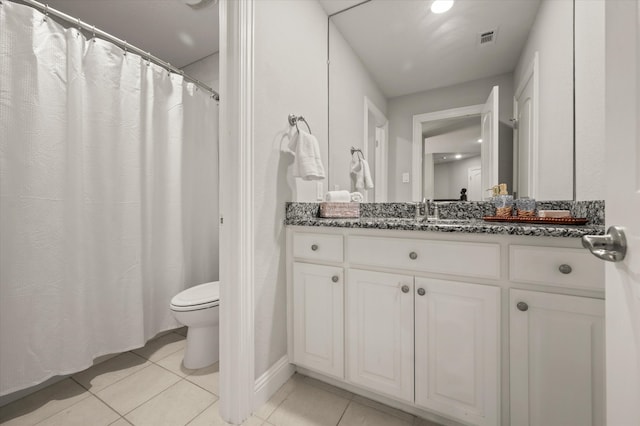 bathroom featuring tile patterned floors, vanity, and toilet