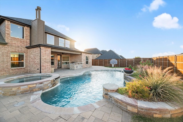 view of swimming pool featuring a fenced backyard, a pool with connected hot tub, and a patio area