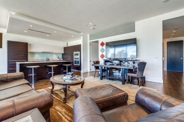 living room with sink and hardwood / wood-style flooring