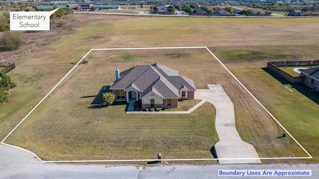 french country home with a front lawn and a garage