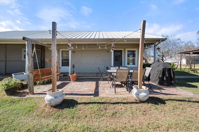 rear view of property featuring a lawn and a patio area