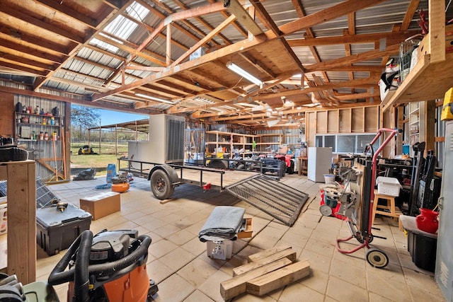 misc room featuring lofted ceiling and a workshop area