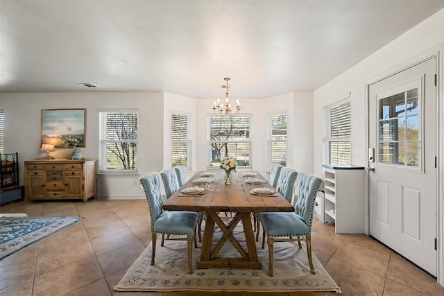 tiled dining area with a notable chandelier