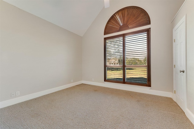 carpeted empty room featuring lofted ceiling