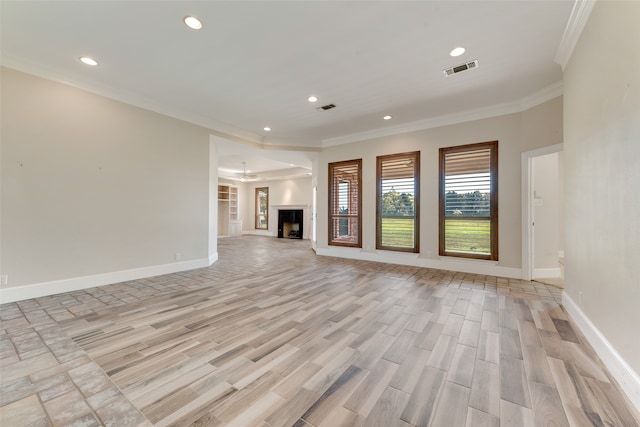 unfurnished living room featuring crown molding and light wood-type flooring