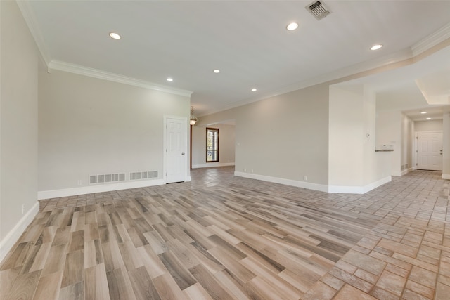 spare room featuring crown molding and light hardwood / wood-style floors