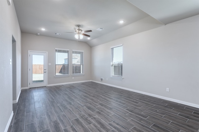 unfurnished room featuring ceiling fan, lofted ceiling, and dark wood-type flooring