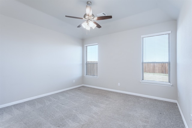 carpeted spare room featuring ceiling fan