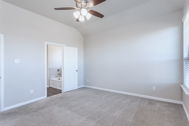 unfurnished bedroom featuring lofted ceiling, carpet floors, and multiple windows