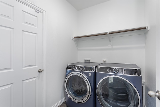 clothes washing area featuring washer and clothes dryer