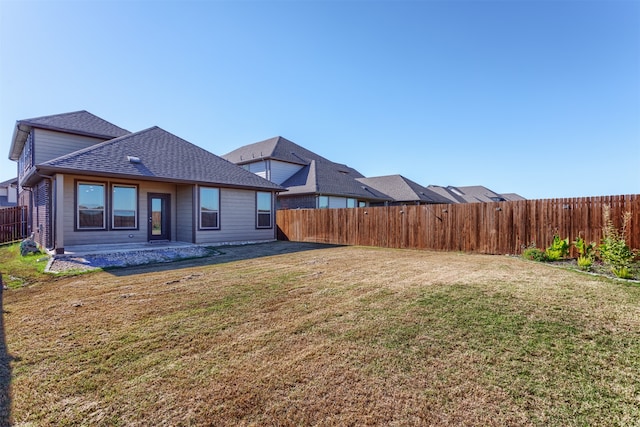 rear view of house with a patio area and a yard