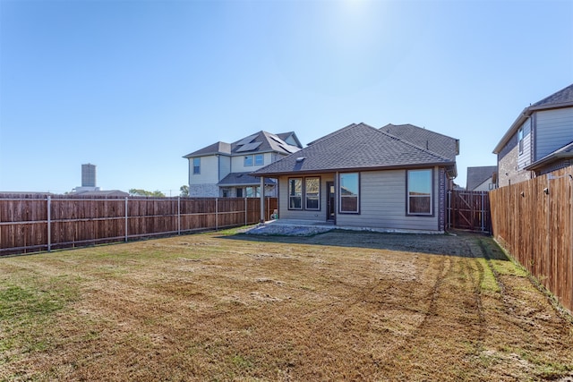 rear view of property with a lawn