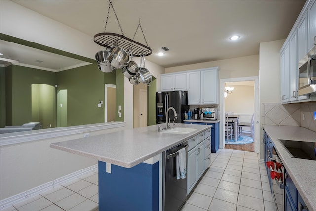 kitchen featuring decorative backsplash, appliances with stainless steel finishes, a center island with sink, white cabinetry, and light tile patterned flooring