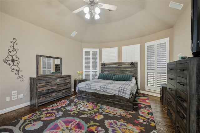 bedroom featuring ceiling fan, dark hardwood / wood-style flooring, and vaulted ceiling