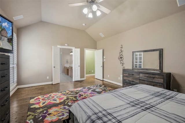 bedroom featuring ensuite bath, ceiling fan, dark hardwood / wood-style flooring, and lofted ceiling