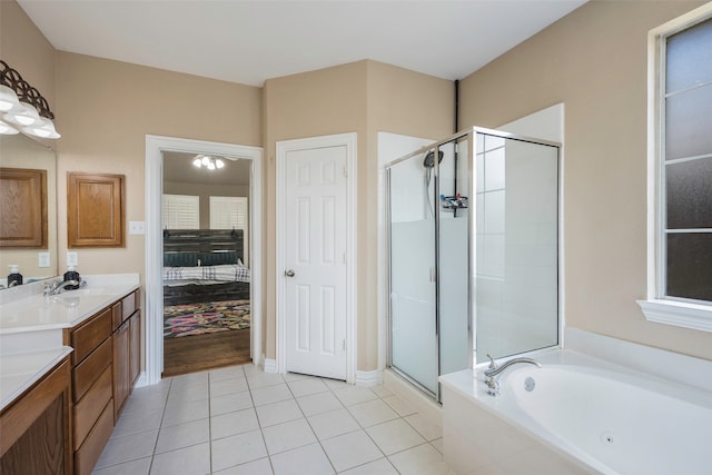 bathroom featuring tile patterned floors, vanity, and plus walk in shower