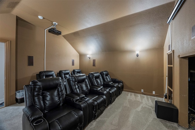 cinema featuring a textured ceiling, lofted ceiling, and light carpet