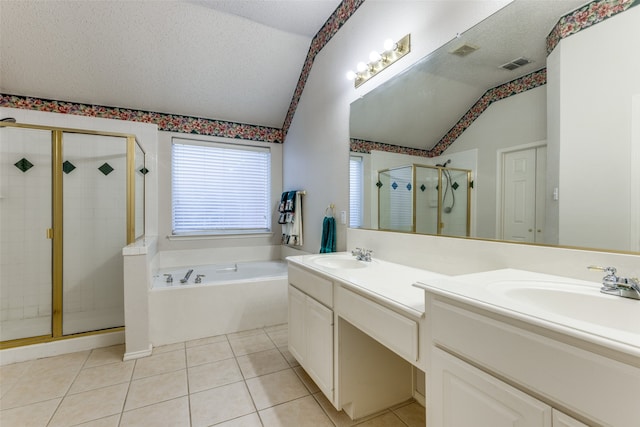 bathroom with plus walk in shower, a textured ceiling, tile patterned floors, and lofted ceiling