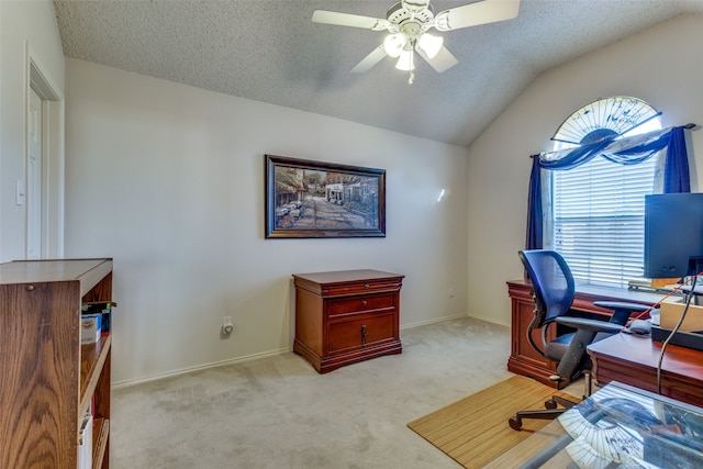 home office with ceiling fan, light colored carpet, lofted ceiling, and a textured ceiling