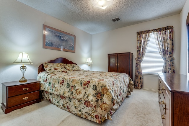 carpeted bedroom featuring a textured ceiling