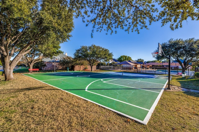 view of sport court with a yard