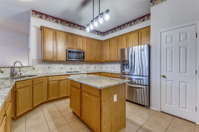 kitchen featuring pendant lighting, a center island, light tile patterned floors, appliances with stainless steel finishes, and light stone counters