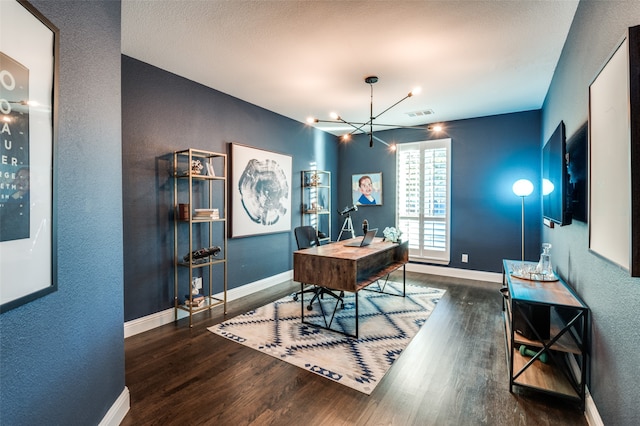 home office featuring visible vents, baseboards, dark wood finished floors, a textured wall, and a chandelier