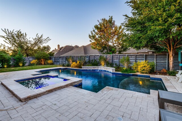 view of swimming pool with an in ground hot tub and a patio