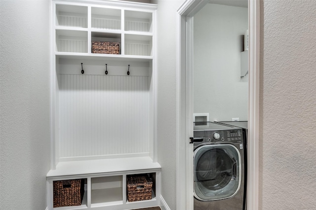 mudroom featuring a textured wall and washer / clothes dryer