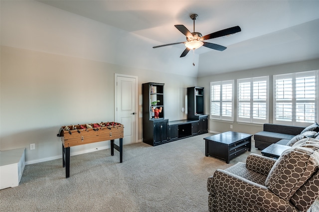 carpeted living area with ceiling fan, lofted ceiling, and baseboards