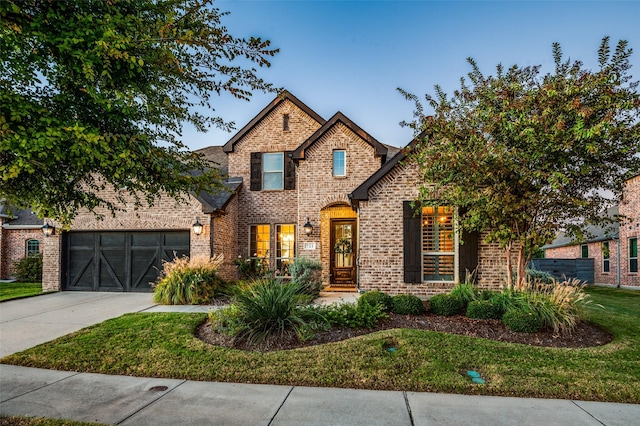 view of front of property with a garage, concrete driveway, brick siding, and a front lawn