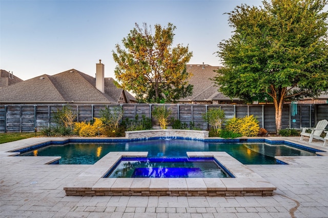 view of pool featuring a patio area, a fenced backyard, a fenced in pool, and an in ground hot tub