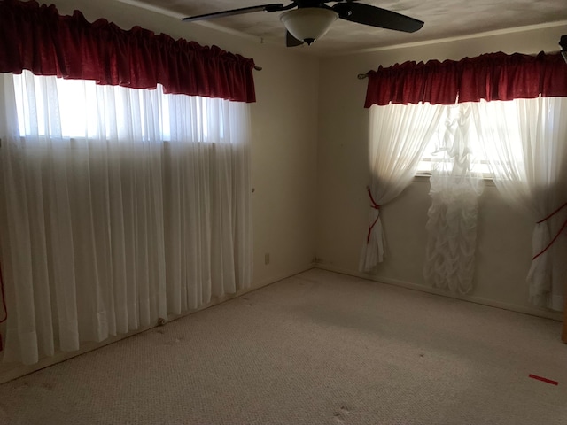 empty room with light colored carpet and ceiling fan