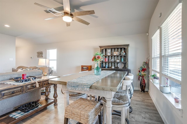 dining space featuring light wood-type flooring and ceiling fan