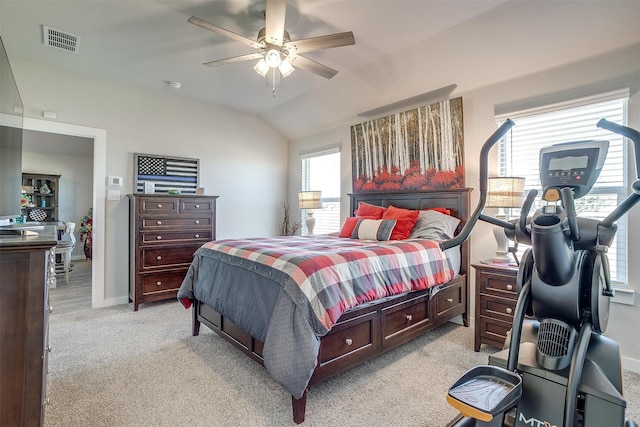 carpeted bedroom with ceiling fan and vaulted ceiling