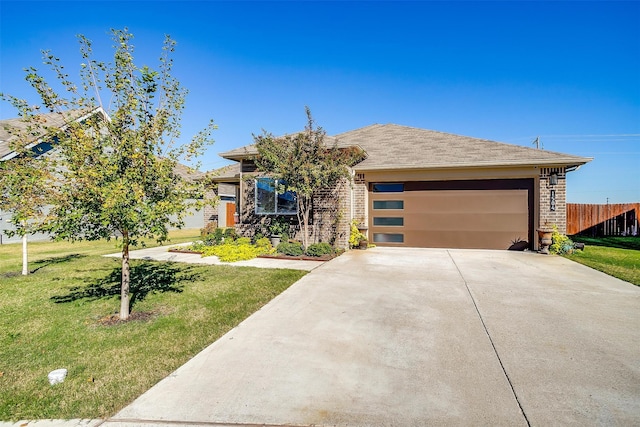 prairie-style house featuring a garage and a front lawn