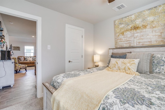 bedroom with hardwood / wood-style floors