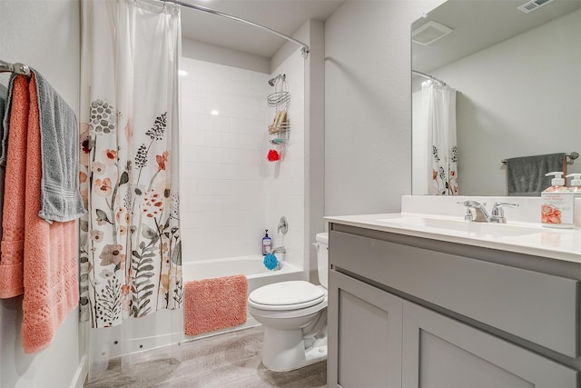 full bathroom featuring vanity, toilet, wood-type flooring, and shower / tub combo with curtain