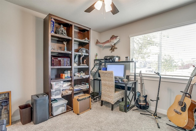 carpeted office space with ceiling fan