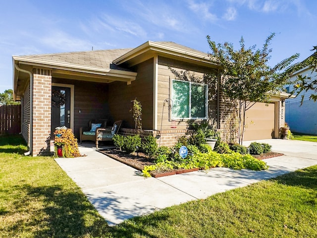 view of front of property with a front yard and a garage