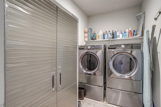 clothes washing area with separate washer and dryer