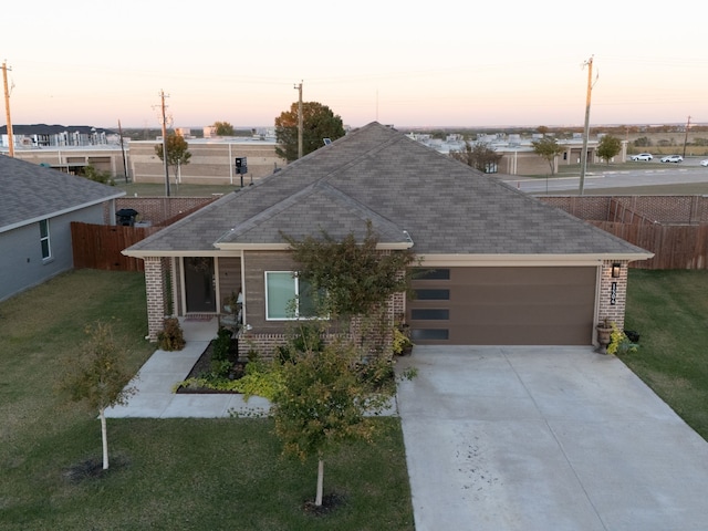 view of front of house featuring a lawn and a garage