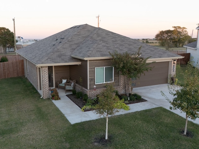 single story home with a lawn and a garage