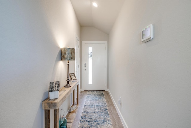 entryway featuring light hardwood / wood-style floors and vaulted ceiling