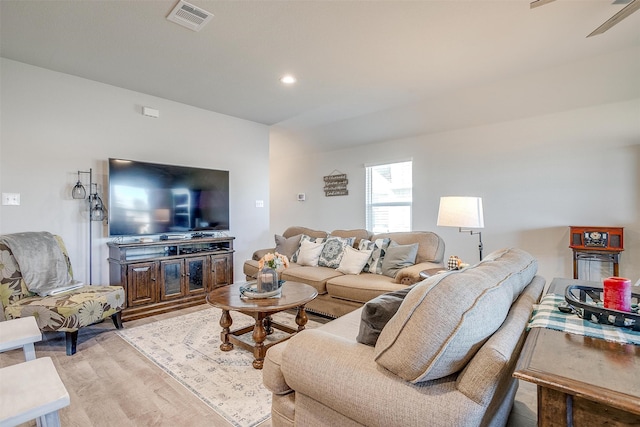 living room with ceiling fan and light wood-type flooring