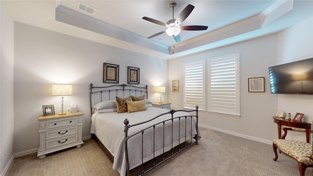 carpeted bedroom featuring ceiling fan, a raised ceiling, and crown molding