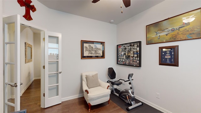 living area with ceiling fan and dark hardwood / wood-style flooring