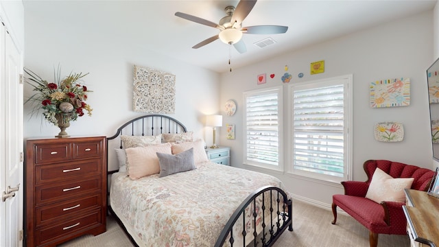 bedroom featuring ceiling fan and light carpet