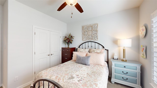 bedroom featuring carpet, ceiling fan, and a closet